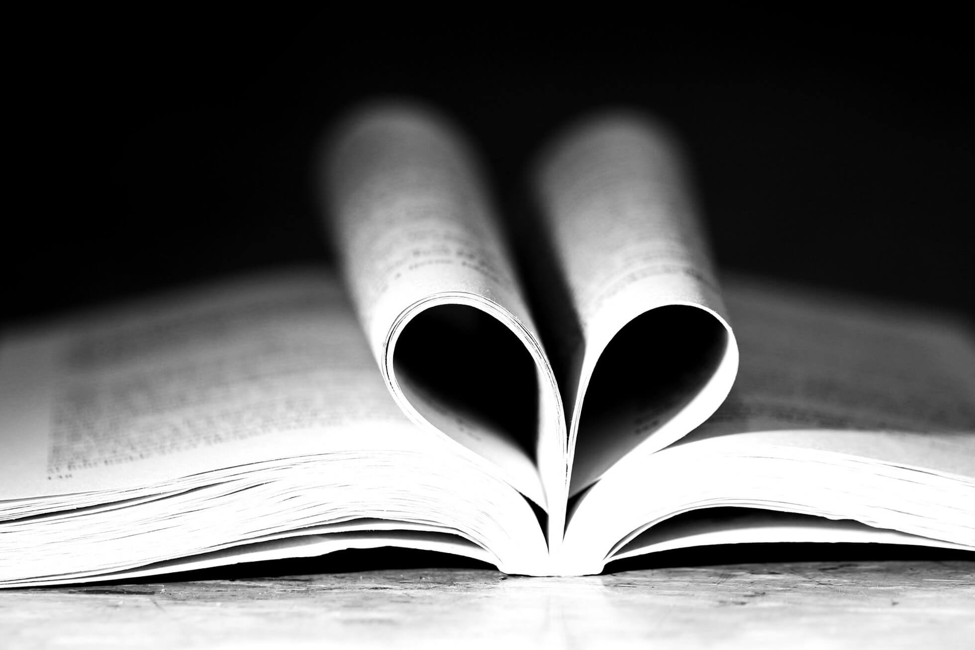 a book open flat with its middle pages folded in half to resemble a heart shape