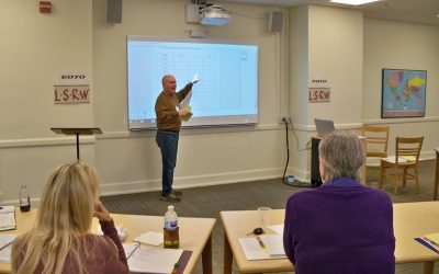 Ed Lee demonstrates smart board use to new tutors